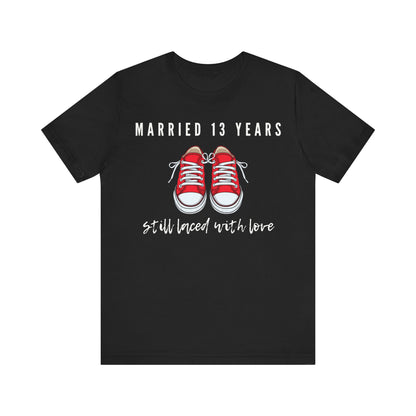 Black anniversary T-shirt with the text Married 13 Years Still Laced With Love around two cartoon sneakers