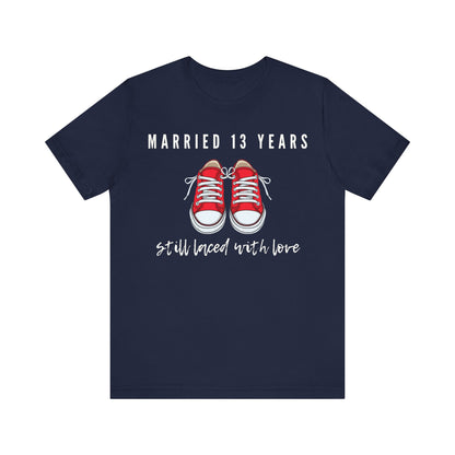 Navy anniversary T-shirt with the text Married 13 Years Still Laced With Love around two cartoon sneakers