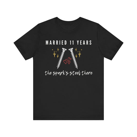 Black anniversary t-shirt with the text Married 11 Years The Spark’s Steel There around two cartoon screws