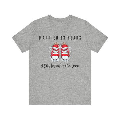 Grey anniversary T-shirt with the text Married 13 Years Still Laced With Love around two cartoon sneakers