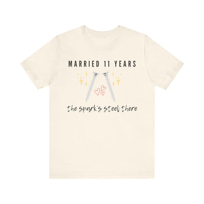 Natural anniversary t-shirt with the text Married 11 Years The Spark’s Steel There around two cartoon screws