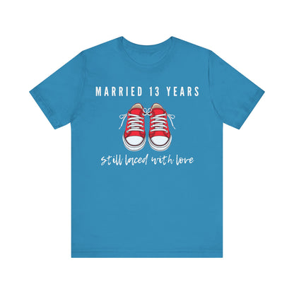 Aqua anniversary T-shirt with the text Married 13 Years Still Laced With Love around two cartoon sneakers