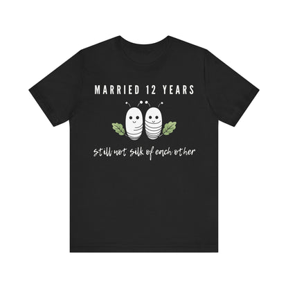 Black anniversary T-shirt with the text Married 12 Years Still Not Silk Of Each Other around two cartoon silkworms